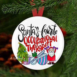 May include: A white Christmas ornament with the text "Santa's Favorite Occupational Therapist" in black and red. The ornament features a Christmas tree, Santa Claus, and therapy tools.
