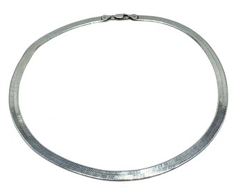 May include: A silver snake chain necklace. The chain is made of interlocking links that create a smooth, continuous surface.