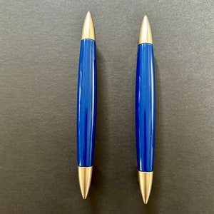 May include: Two blue and silver cabinet pulls with a pointed tip.