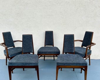May include: Set of five mid-century modern dining chairs with dark wood frames and gray fabric upholstery.