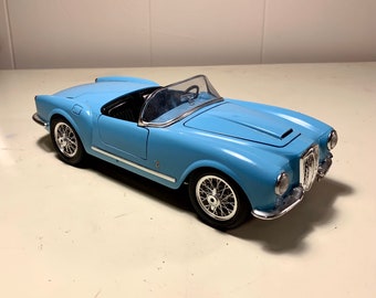 Lancia Aurelia B24 Spider 1955 1:18 Burago – Bleu Clair, Intérieur Crème, Sans Boîte
