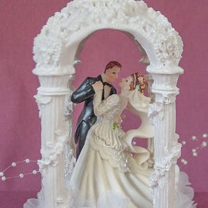 Elegant gazebo customized wedding cake topper graced with bride and groom with your hair color. Ethnic skin and clothing alteration available. Several poses to choose from.