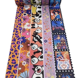 May include: A set of six decorative washi tapes featuring various designs, including a leopard print, floral pattern, cartoon cats, a glitter stripe, and a Halloween theme with witches and a castle.