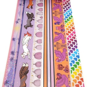 May include: A set of six washi tapes featuring various designs, including foxes, pumpkins, birds, and hearts. The tapes are colorful and have a variety of patterns.