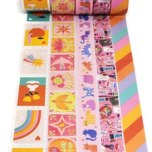 May include: Five rolls of colorful washi tape with different patterns. The patterns include a rainbow, a bird, a flower, a cat, and a variety of art supplies.