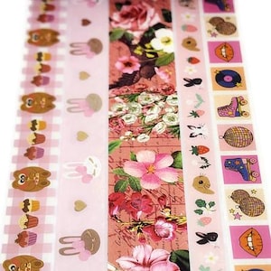 May include: Five rolls of pink and white patterned washi tape. The tapes feature designs of cupcakes, bunnies, flowers, butterflies, and roller skates.