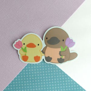 Platypus and Duck Friends Vinyl Sticker. Platypus and Duckling Decal. Cute Animal Friends Holding Flowers. Spring / Summer Stationery