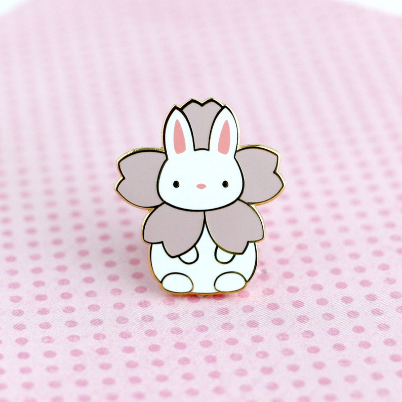 Enamel pin of a little bunny wearing a pink sakura flower costume