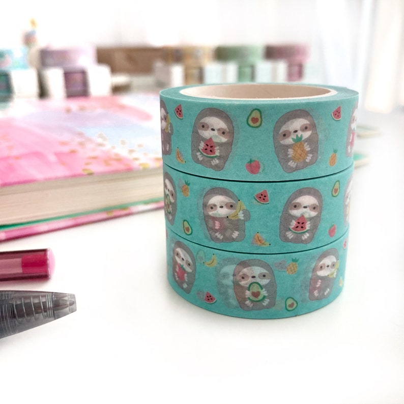 Three rolls of green washi tape featuring fruits and cute sloth holding fruits