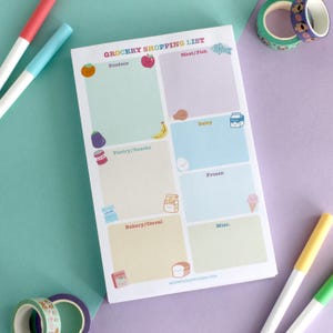 May include: A grocery shopping list notepad with colorful sections for produce, meat/fish, dairy, pantry/snacks, frozen, bakery/cereal, and misc. Includes cute illustrations of food items. The text "GROCERY SHOPPING LIST" is at the top.