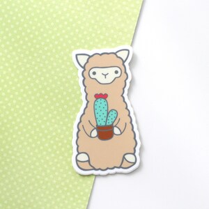 Vinyl sticker of a standing alpaca (or llama) holding a cactus
