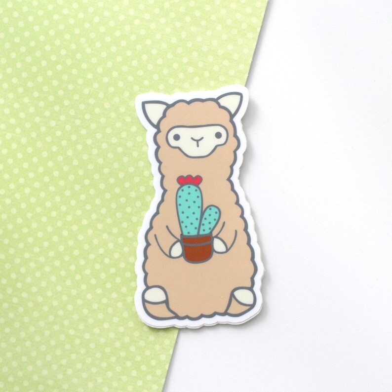 Vinyl sticker of a standing alpaca (or llama) holding a cactus