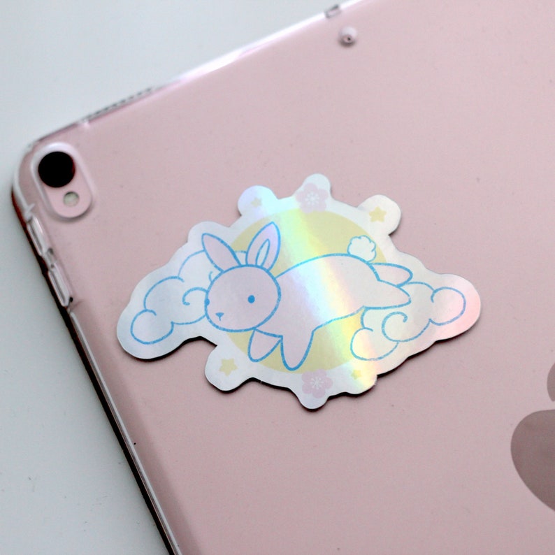 Tablet decorated with holographic sticker of a bunny with moon and clouds