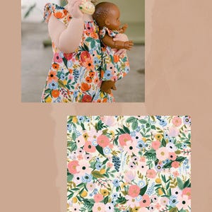 May include: A sleeveless dress featuring a vibrant floral pattern with pink, orange, and blue flowers on an ivory background. The text PETITE ORCHARD IN IVORY is displayed at the bottom. The dress has ruffled sleeves and a loose, comfortable fit.