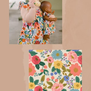 May include: A sleeveless dress featuring a vibrant floral pattern with red, pink, yellow, and blue flowers on a cream background. The fabric displays a repeating botanical print of various blossoms and green leaves, with the text VINTAGE GARDEN below.