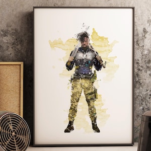 May include: Watercolour print of a person in military-style attire, holding a weapon. The artwork features a yellow and brown background with paint splatters. The person is wearing camouflage trousers and a dark jacket.