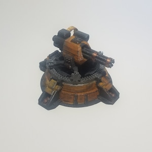 May include: A miniature, 3D printed, steampunk-style, rotating turret with a multi-barreled gun. The turret is painted in shades of brown and black, with a yellow accent on the top.