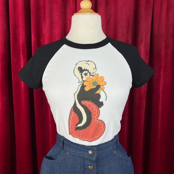 Little Stinker Short Raglan Cropped Baby Graphic T-shirt in White/Black size S, M, L,XL, 2XL vintage inspired by Mischief Made, Skunk