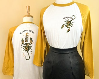 The Scorpion Unisex Raglan Graphic T-shirt in White x Mustard Vintage inspired by Mischief Made