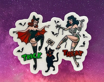 May include: A Halloween-themed sticker featuring two pin-up style women dressed as a bat and a mummy. A black cat holds a sign that says "OR". The words "TRICK" and "TREAT" are also included in the design. The background is a gradient of purple and pink.