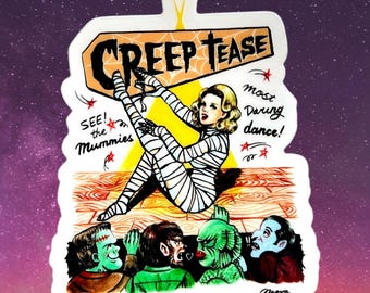May include: A sticker featuring a vintage-style illustration of a woman in mummy bandages, with the text "Creep Tease." The image includes classic monster characters and the phrase "most daring dance!" against a purple and starry background.