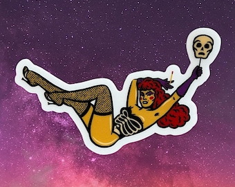 May include: A sticker featuring a stylized illustration of a reclining figure with red hair, holding a skull mask. The figure is wearing fishnet stockings and a skeleton-themed top, set against a purple and pink galaxy background.