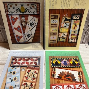 May include: Four colorful runner patterns from the "Runner of the Month Series" are displayed. Each pattern features a unique design, including hearts, flowers, and geometric shapes. The patterns are printed on paper and are approximately 14 to 17.5 inches wide and 40 to 47 inches long.