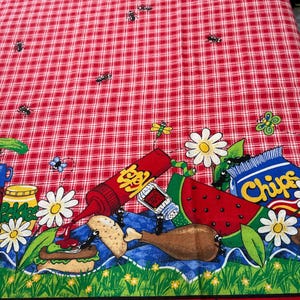 May include: Red and white checkered picnic tablecloth with a colorful border featuring cartoon illustrations of food items like watermelon, chips, and a hamburger. The border also includes daisies and insects.