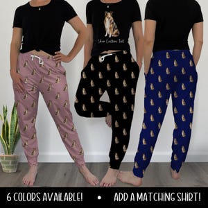 May include: Three pairs of sweatpants in different colors: mauve, black, and navy blue. Each pair features a repeating pattern of a dog. A black t-shirt with a dog graphic and the text "Your Custom Text" is also shown. The text "6 COLORS AVAILABLE!" and "ADD A MATCHING SHIRT!" are at the bottom.