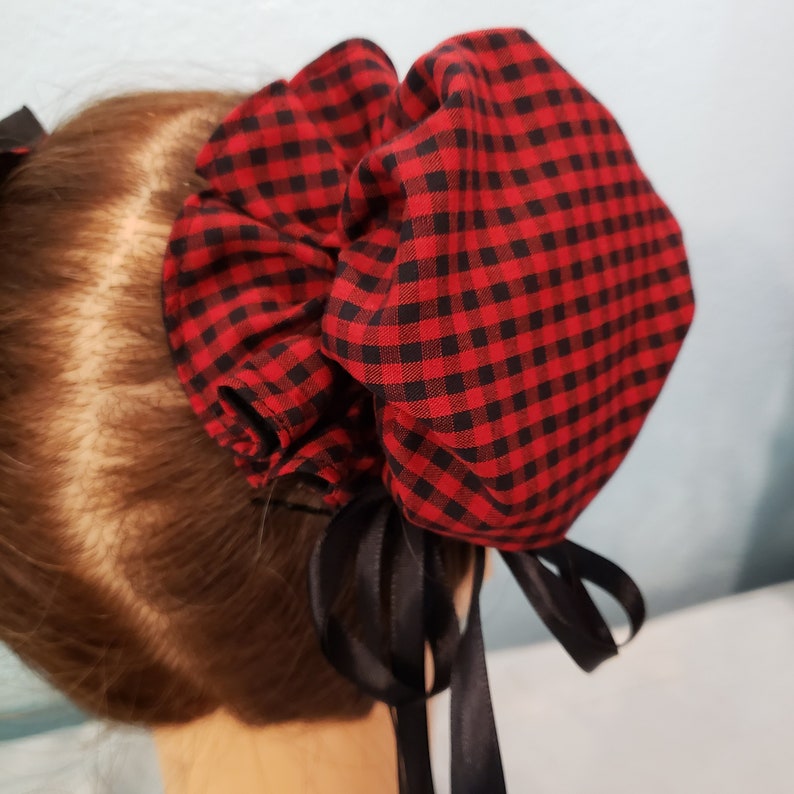 May include: Red and black checkered fabric hair scrunchie with black satin ribbon ties.