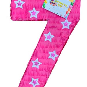 May include: A bright pink number seven piñata decorated with white stars with glitter centers. A colorful card with the text "APINATA 4U" is attached. The piñata is designed for a birthday celebration.