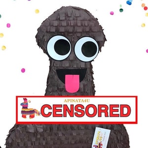 May include: A brown piñata with large white and black eyes, a black mouth, and a pink tongue. The piñata is decorated with a fringe-like texture and has a censored banner across the front. Colorful confetti is scattered around the piñata.