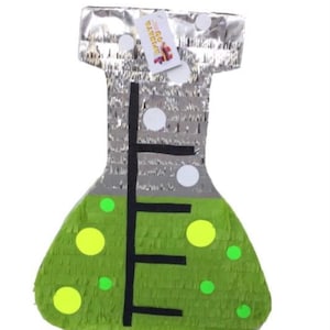 May include: A piñata shaped like a laboratory flask, with a green, textured base and a silver top. The flask has a black measurement scale and is decorated with yellow and green circles. A tag with text is attached to the top.