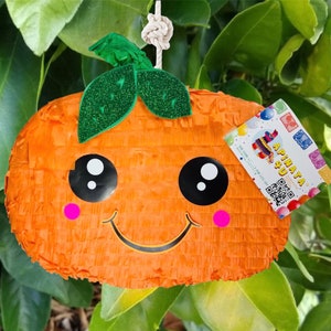 May include: Orange pumpkin shaped pinata with a cute cartoon face, green leaves, and pink cheeks. The pinata is hanging from a white string. The text on the tag reads "Piñata 4 U".