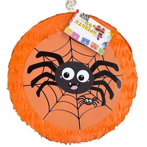 May include: Orange spider piñata with a black spider and web design. The piñata has a tag that says "Piñata 18" and has a QR code.