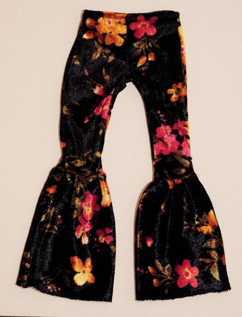 May include: Black velvet bell bottom pants with a floral pattern in shades of orange, yellow, and pink.