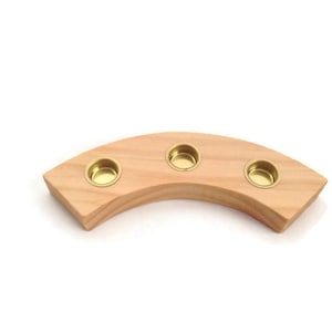 May include: A wooden candle holder with a curved shape and three brass candle cups.