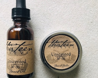May include: A set of beard care products from Thirteen Thieves. The set includes a brown glass bottle with a dropper labeled "Unscented No 00 Beard Oil" and a silver tin labeled "Unscented No 00 Beard Balm".