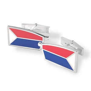 May include: A pair of silver cufflinks with a red, white, and blue enamel design. The design resembles a flag.