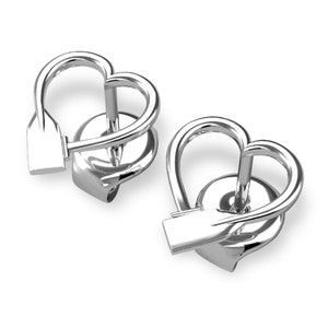 May include: A pair of silver heart-shaped earrings with a small oar detail. The earrings are designed to look like a heart with a small oar going through the center.