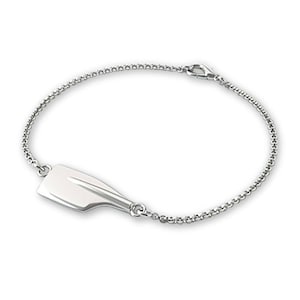 May include: A silver bracelet with a silver oar charm. The bracelet has a delicate chain and a lobster clasp.