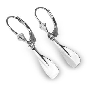 Peut inclure: Une paire de boucles d'oreilles pendantes en argent avec un design en forme de pagaie. Les boucles d'oreilles ont une fermeture à levier.