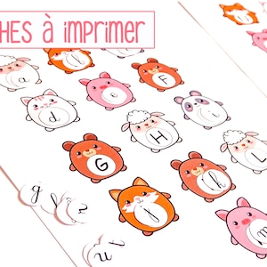 May include: Printable alphabet flashcards featuring cute animal illustrations. Each card has a different animal with a letter of the alphabet on it. The animals are drawn in a cartoon style and are colorful. The text "FICHES à IMPRIMER" is at the top of the image.