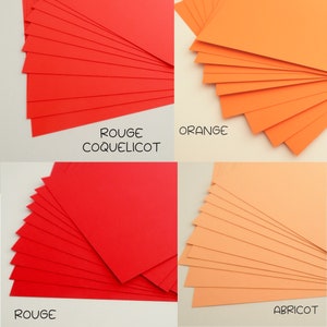 May include: Four stacks of colored cardstock paper. The top row shows red, orange, the bottom row shows red and apricot.