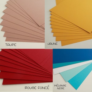 May include: Assortment of cardstock paper in various colors, including taupe, yellow, red, blue, turquoise, and white. The paper is arranged in stacks, with each stack fanned out to show the color.