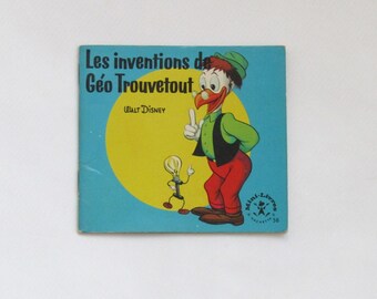 May include: A vintage children's book titled "Les inventions de Géo Trouvetout" by Walt Disney. The cover features a cartoon character in a green shirt, black vest, and red pants, with a yellow circle and a light blue background.
