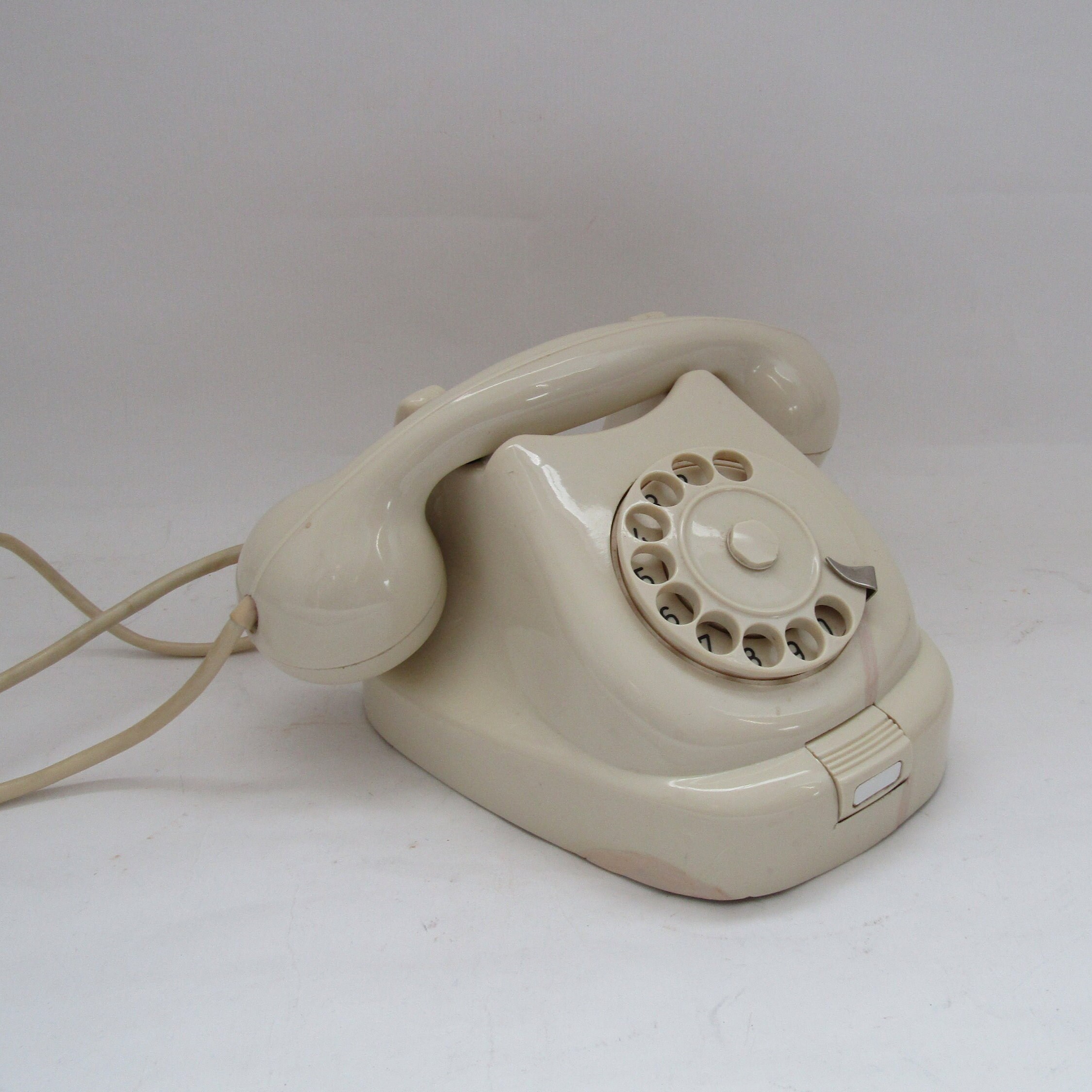 Details with a white old fashioned dial rotary phone from the