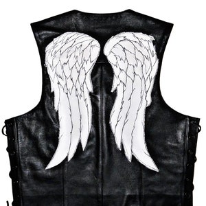 May include: Black leather vest with white angel wings on the back. The vest has a lace-up design on the sides.
