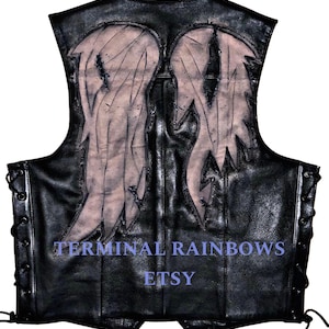 May include: Black leather vest with a white angel wing design on the back. The vest has a lace-up front and the text "TERMINAL RAINBOWS ETSY" on the bottom.