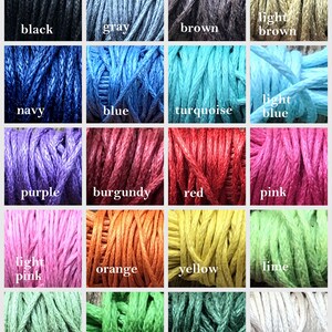 May include: A color chart of 16 different colors of embroidery floss. The colors are: black, gray, brown, light brown, navy, blue, turquoise, light blue, purple, burgundy, red, pink, light pink, orange, yellow, lime, light green, green, dark green, and white.